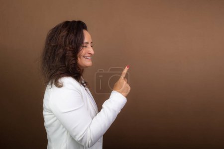 Photo for Portrait of coaching woman making hand gesture. Concept of democratic and motivating manager. Isolated on brown background. - Royalty Free Image
