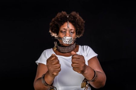 Photo for Portrait of a black woman in chains with an iron mask on her face, representing the slave Anastacia. Slavery in Brazil. - Royalty Free Image