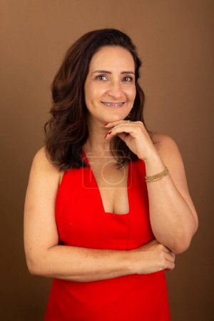 Photo for Portrait of beautiful confident cheerful woman. Emotional maturity concept. Motivating person. Isolated on brown background. - Royalty Free Image