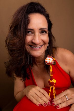 Photo for Cheerful coaching woman with a giraffe puppet. Symbol of non-violent communication. Isolated on brown background. - Royalty Free Image