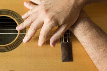 Photo for Hands on top of a classical guitar. Quality music - Royalty Free Image