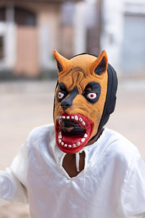 Photo for Santo Amaro, Bahia, Brazil - July 19, 2015: An unidentified person is seen wearing a horror costume and mask in the Acupe district in the city of Santo Amaro, Bahia. - Royalty Free Image