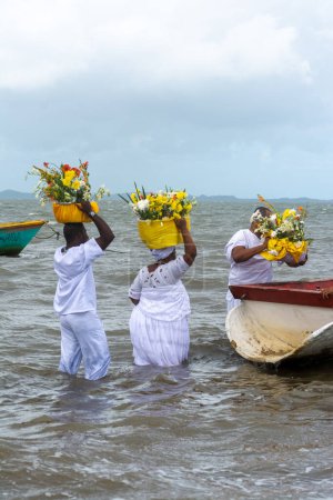 Photo for Santo Amaro, Bahia, Brazil - May 17, 2015: Candomble members are seen taking gifts to iemanja on Itapema beach in the city of Santo Amaro, Bahia. - Royalty Free Image