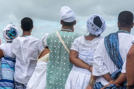 Photo for Santo Amaro, Bahia, Brazil - May 17, 2015: Members of Candomble are seen watching the sea and the Bembe do Mercado celebrations on Itapema beach in the city of Santo Amaro, Bahia. - Royalty Free Image