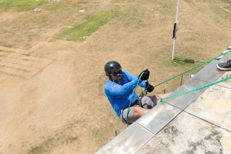 Salvador, bahia, Brazil - January 07, 2024: Rappelist preparing to descend the rope carefully. Healthy sport.