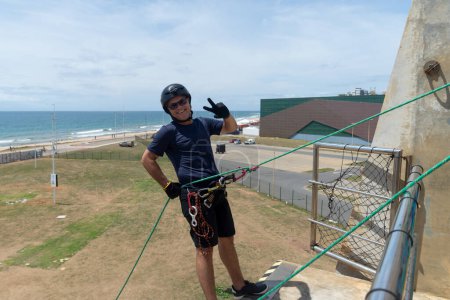 Salvador, bahia, Brazil - January 07, 2024: Rappelist giving a thumbs up before descending from a great height. Healthy sport. Lifestyle.