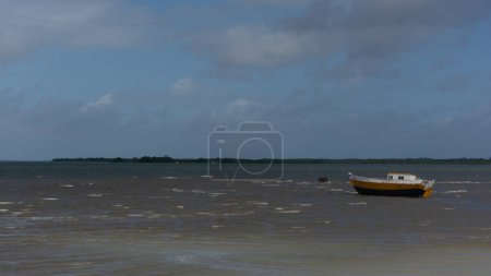 Photo for Fishing boat anchored on the beach waiting to go out to sea. City of Santo Amaro, Bahia. - Royalty Free Image