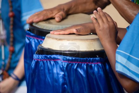 Percussionist hands playing atabaque. musical rhythm. African music. Tribute to Iemanja.
