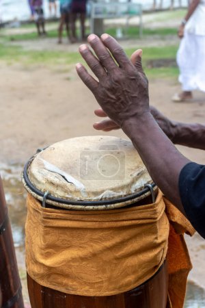 Hands of a percussionist playing atabaque at a religious event. Candomble celebration.