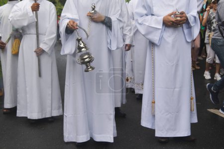 Photo for Salvador, Bahia, Brazil - April 14, 2019: Catholic seminarians are seen participating in the Palm Sunday procession with incense in the city of Salvador, Bahia. - Royalty Free Image