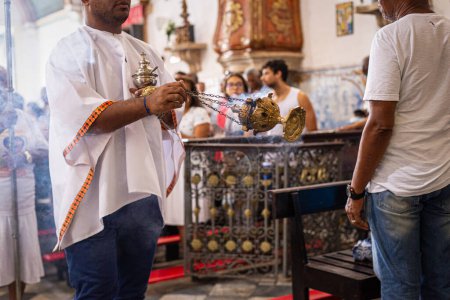 Photo for Salvador, Bahia, Brazil - May 12, 2019: Catholic faithful are seen during mass at the Rosario dos Pretos church in Pelourinho, the historic center of the city of Salvador, Bahia. - Royalty Free Image