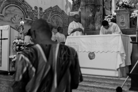 Photo for Salvador, Bahia, Brazil - May 12, 2019: Catholic and Candomble faithful are seen during mass at the Rosario dos Pretos church in Pelourinho. City of Salvador, Bahia. - Royalty Free Image