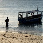 Salvador, Bahia, Brazil - April 13, 2019: Fishermen are seen on a boat on Ribeira beach in the city of Salvador, Bahia.