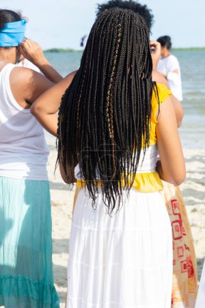 Photo for Santo Amaro, Bahia, Brazil - May 19, 2019: Members of Umbanda are participating in the tribute to Iemanja on Itapema beach in the city of Santo Amaro, Bahia. - Royalty Free Image