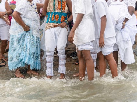 Photo for Santo Amaro, Bahia, Brazil - May 19, 2019: Members of Candomble are seen participating in the tribute to iemanja on Itapema beach in the city of Santo Amaro, Bahia. - Royalty Free Image