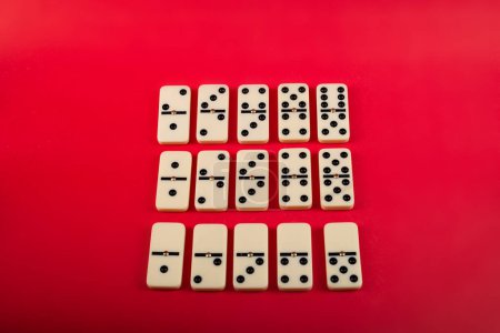Dominoes on a red background. White Bones Board Game.