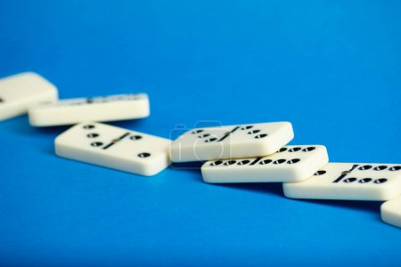  Connected dominoes on a blue background. board games concept