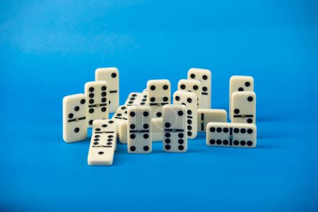 Dominoes with blue background, copy space and various angles. White Bones Board Game.