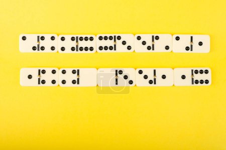 Dominoes on a yellow background.  