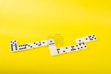 Dominoes on a yellow background. White Bones Board Game.