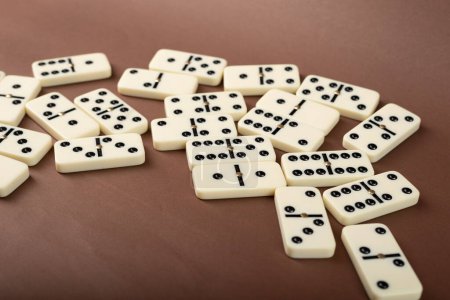 Dominoes with brown background, copy space and various angles, board games concept