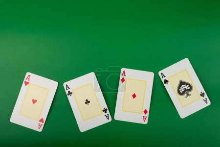 Playing cards isolated on green background. Gambling.