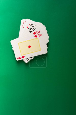 Photo for Playing cards for poker and gambling, isolated on green background. - Royalty Free Image