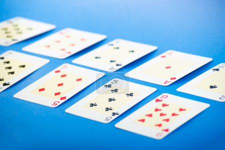 Playing cards isolated on blue background. Gambling.