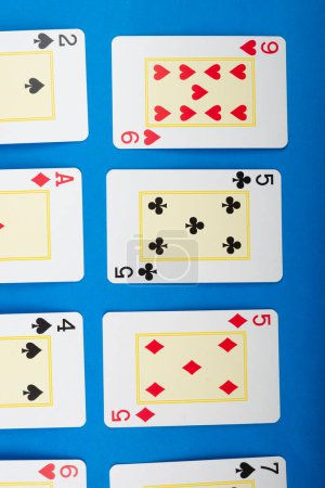 Photo for Playing cards for poker and gambling, isolated on blue background. - Royalty Free Image