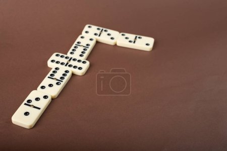 Dominoes on a brown background. White Bones Board Game.