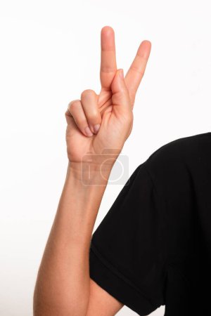 Close-up of a hand making the letter H in Brazilian sign language for the deaf, Libras. Isolated on white background.