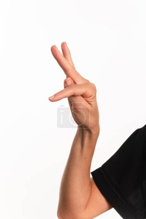 Close-up of a hand making the letter T in the sign language for the deaf in Brazil, Libras. Isolated on white background.