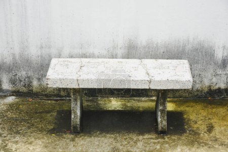 White cement chairs with water on the floor