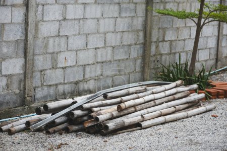 Photo for A pile of bamboo sticks was piled up against the wall. - Royalty Free Image