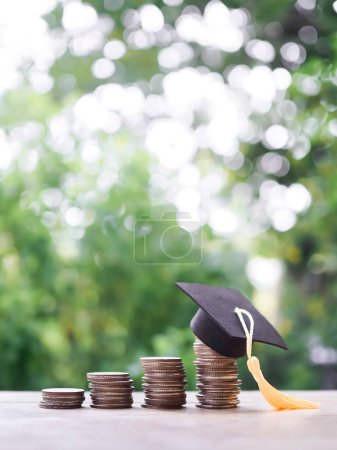 Graduation hat on stack of coins. The concept of saving money for education, student loan, scholarship, tuition fees in future