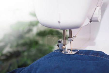 Photo for Close up sewing machine sew seam of blue denim jean. - Royalty Free Image