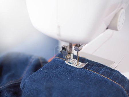 Photo for Close up sewing machine sew seam of blue denim jean. - Royalty Free Image