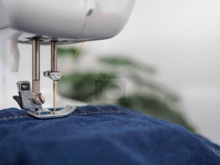 Téléchargez les photos : Gros plan machine à coudre coudre couture de jean denim bleu. - en image libre de droit