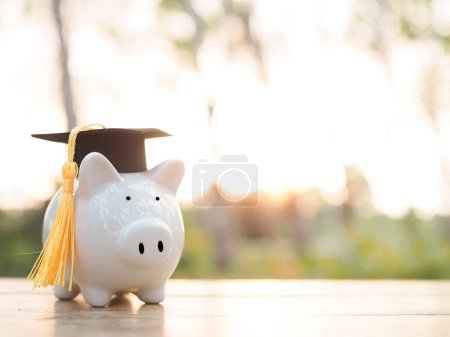Piggy bank with graduation hat. The concept of saving money for education, student loan, scholarship, tuition fees in future