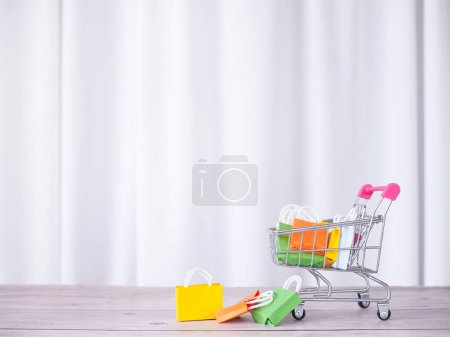 Shopping cart with shopping bags. Concepts about online shopping that offers home delivery