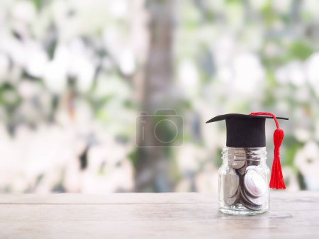 Glass bottle with graduation hat. The concept of saving money for education, student loan, scholarship, tuition fees in the future