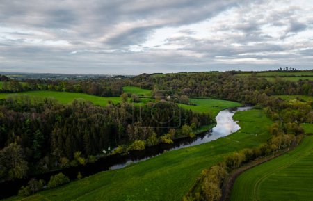 Photo for Nature, trees and a winding river bend in the foreground. Near the Newgrange, Donore, co. Meath in Ireland - Royalty Free Image