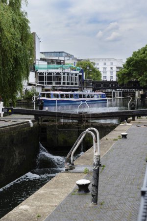 Photo for London - 03 06 2022: Hawley Lock in the foreground and sightseeing boat moored in the background on the Regent's Canal. - Royalty Free Image