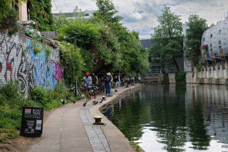 Photo for London - 06 03 2022: People walking and cycling along Regent's Canal Towpath near Camden Gardens. - Royalty Free Image