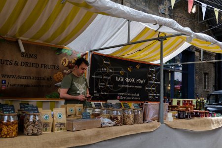 Photo for London - 06 03 2022: Natural products stall in Canopy market in Granary Square - Royalty Free Image