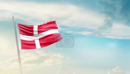 Foto de Denmark waving flag in beautiful sky. - Imagen libre de derechos