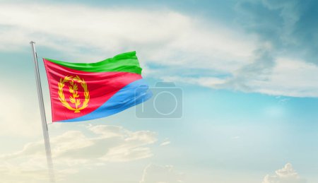 Téléchargez les photos : Eritrea waving flag in beautiful sky. - en image libre de droit