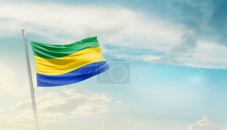 Téléchargez les photos : Gabon waving flag in beautiful sky. - en image libre de droit