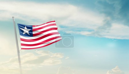 Téléchargez les photos : Liberia waving flag in beautiful sky. - en image libre de droit