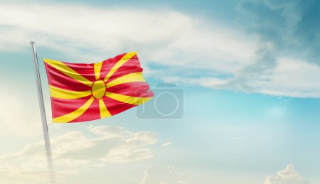 Foto de North Macedonia waving flag in beautiful sky. - Imagen libre de derechos